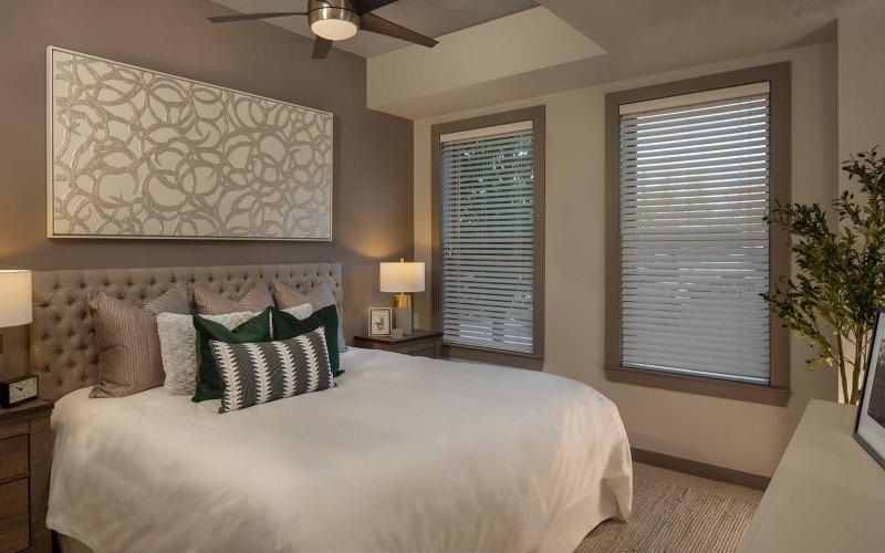 a bedroom with a bed and lamps