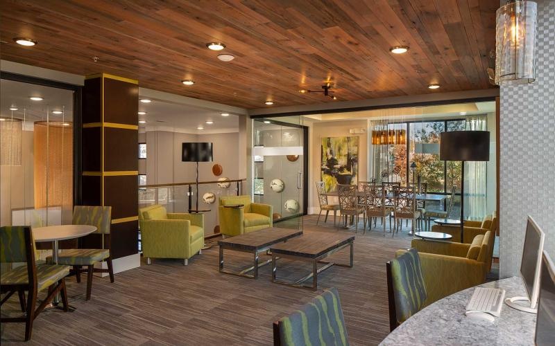 a lounge with a table, chairs, and a couch