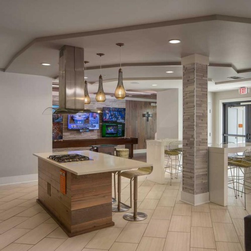 a spacious kitchen with a media area and couches